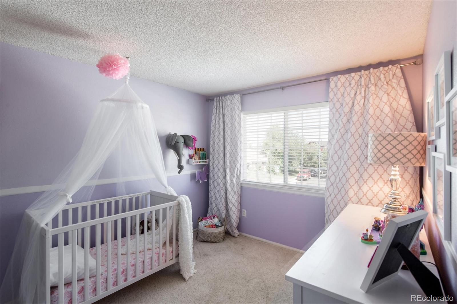 100 Prairie Ridge Road Highlands Ranch, CO 80126 - Photo 23 of 34 a bedroom with a bed and a window