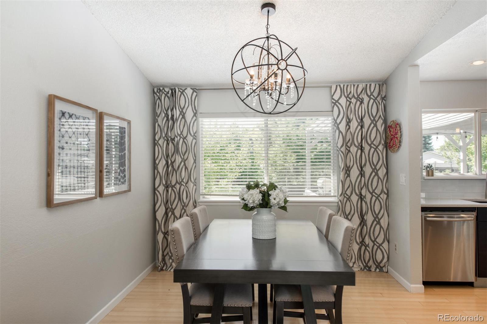 100 Prairie Ridge Road Highlands Ranch, CO 80126 - Photo 6 of 34 a view of a dining room with furniture window and wooden floor