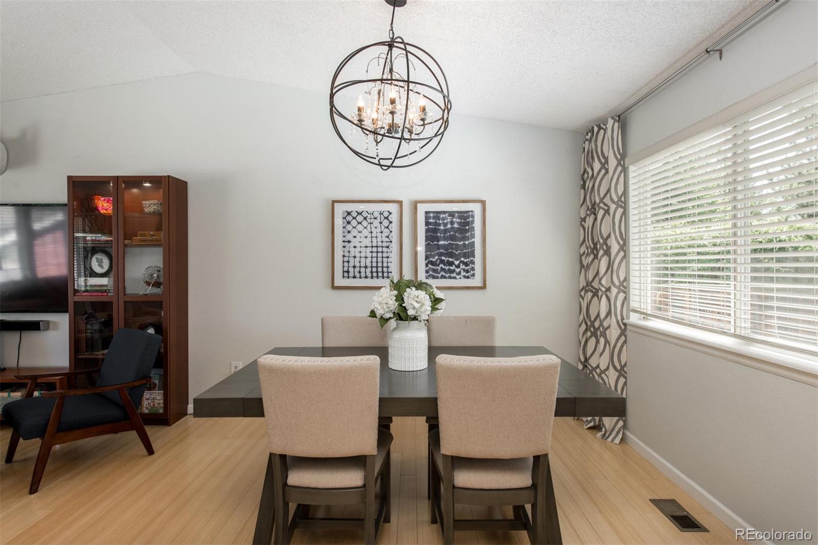 100 Prairie Ridge Road Highlands Ranch, CO 80126 - Photo 7 of 34 a view of a dining room with furniture window and wooden floor