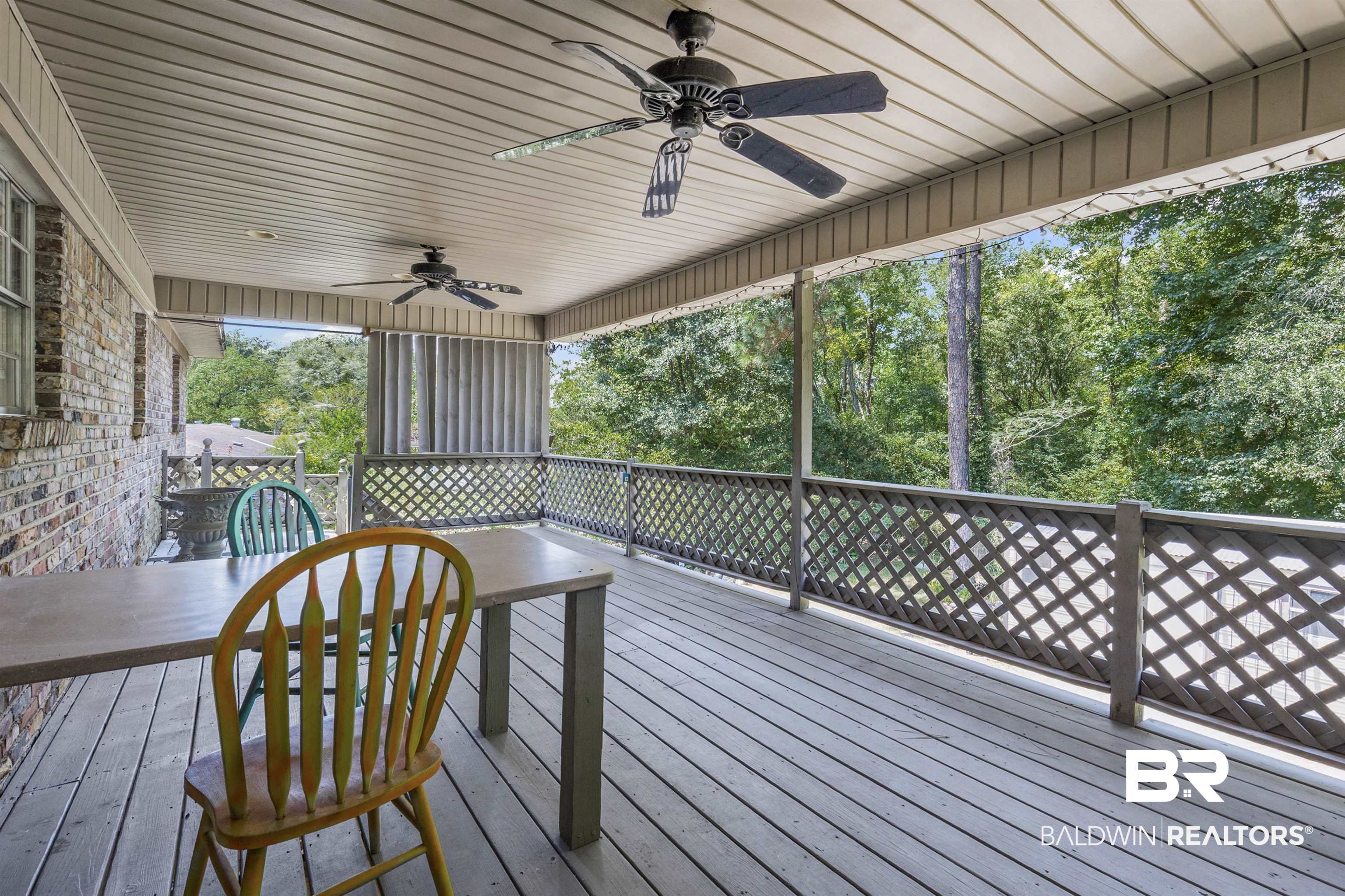 36 Ridgeview Drive Mobile, AL 36611 - Photo 18 of 20 Deck with ceiling fan and view of wooded area