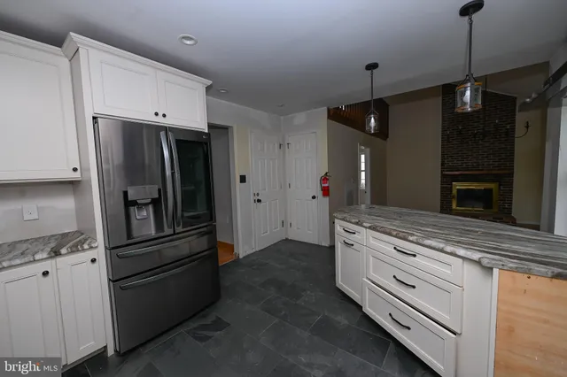 a kitchen with granite countertop stainless steel appliances and refrigerator