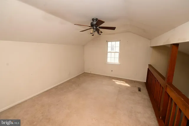 an empty room with windows and cabinet