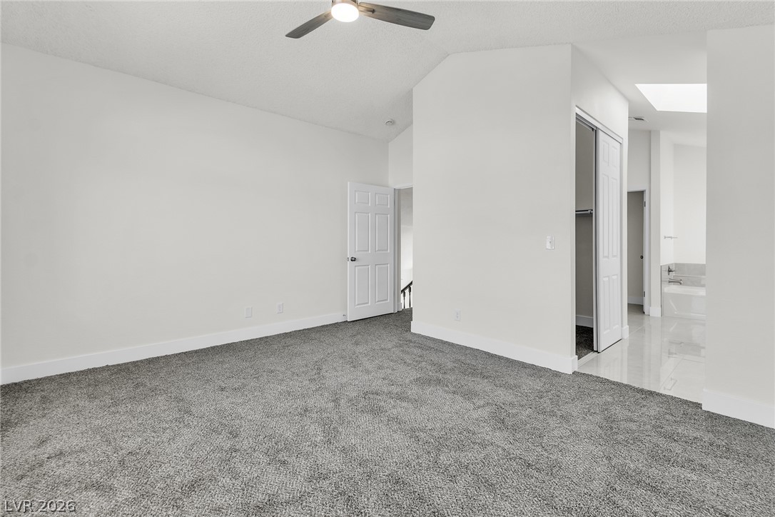 370 Rushing Creek Court Henderson, NV 89014 - Photo 19 of 32 Vaulted ceilings and plush carpeting anchor this light-filled upper-level bedroom suite.