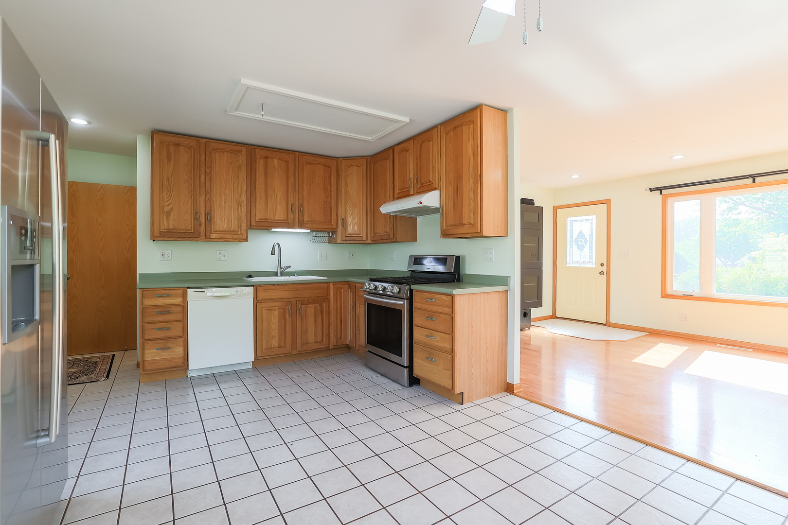 353 Raupp Boulevard Buffalo Grove, IL 60089 - Photo 17 of 28 a kitchen with stainless steel appliances granite countertop a stove a sink and a refrigerator