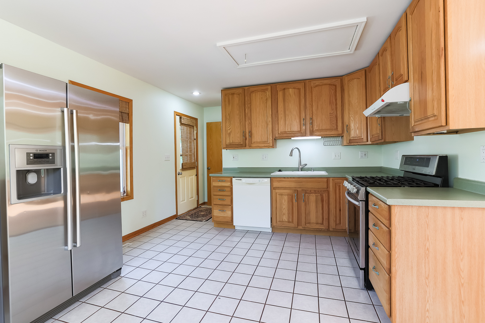 353 Raupp Boulevard Buffalo Grove, IL 60089 - Photo 18 of 28 a kitchen with a cabinets a sink and a refrigerator