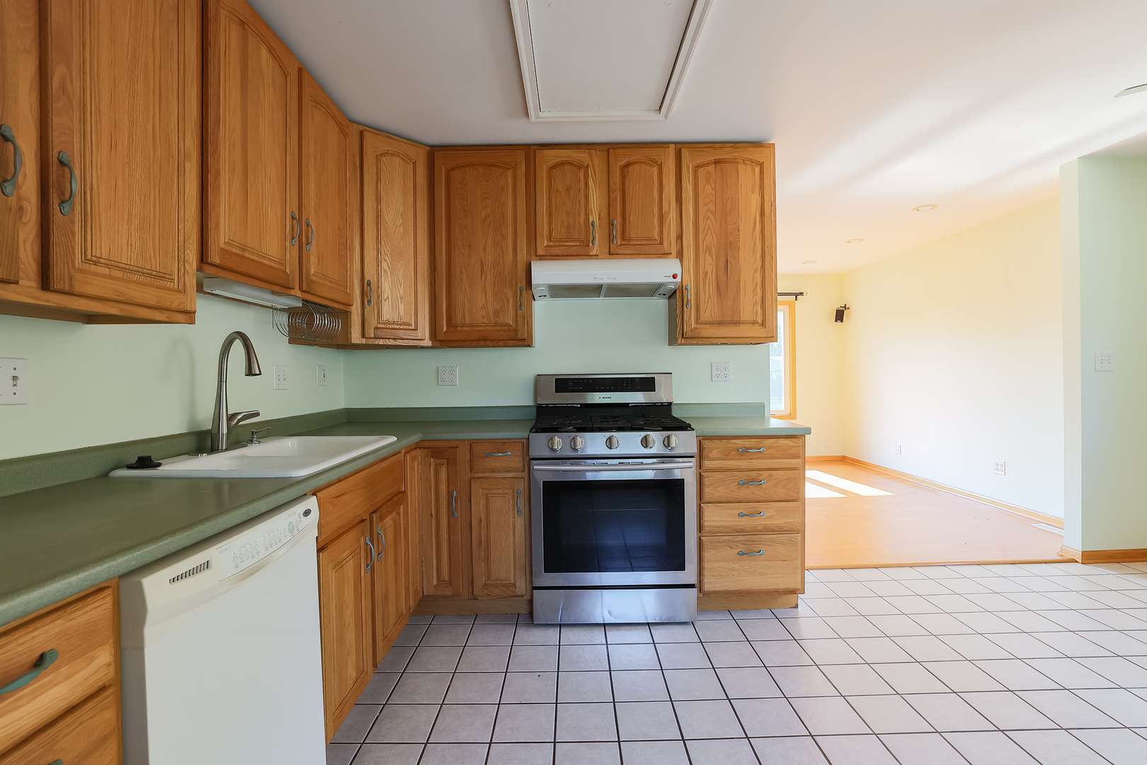 353 Raupp Boulevard Buffalo Grove, IL 60089 - Photo 19 of 28 a kitchen with stainless steel appliances granite countertop a stove a sink and a microwave