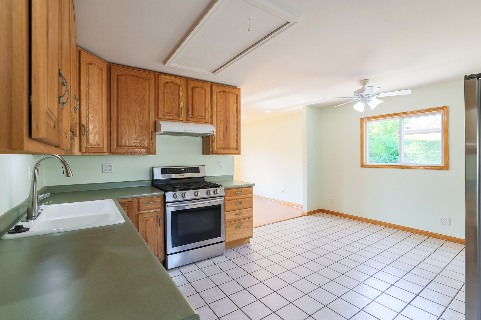 353 Raupp Boulevard Buffalo Grove, IL 60089 - Photo 20 of 28 a kitchen with granite countertop a stove a sink and a microwave