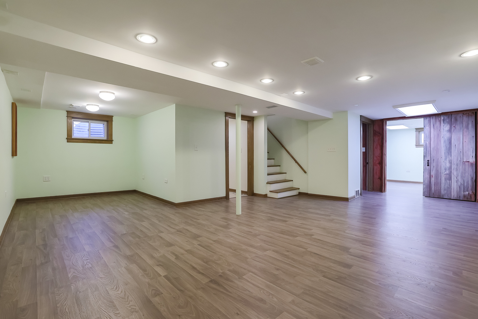 353 Raupp Boulevard Buffalo Grove, IL 60089 - Photo 21 of 28 a view of an empty room with wooden floor and stairs