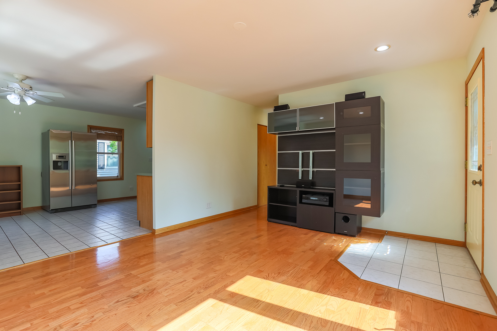 353 Raupp Boulevard Buffalo Grove, IL 60089 - Photo 7 of 28 wooden floor in an empty room with a window