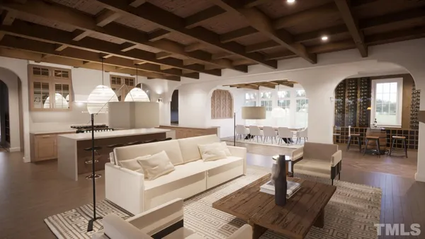 a living room with fireplace furniture and a chandelier