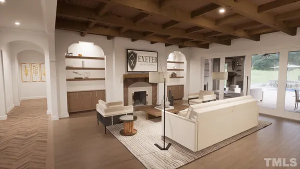 a living room with furniture a fireplace and a chandelier