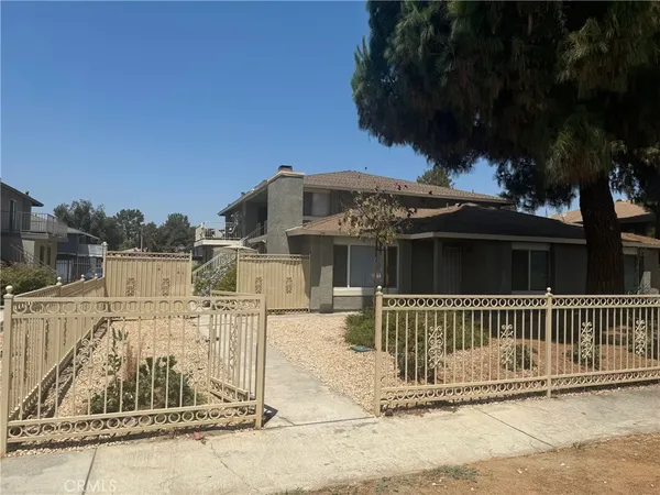 a view of a house with a wooden fence