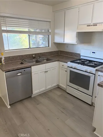 a kitchen with granite countertop a stove and a sink