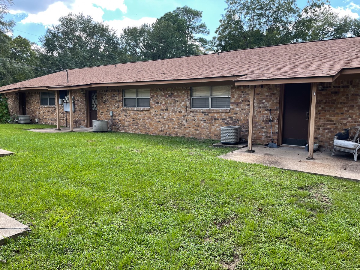 704 Cline Street Huntsville, TX 77340 - Photo 20 of 21 a view of a yard in front of a house with large plants