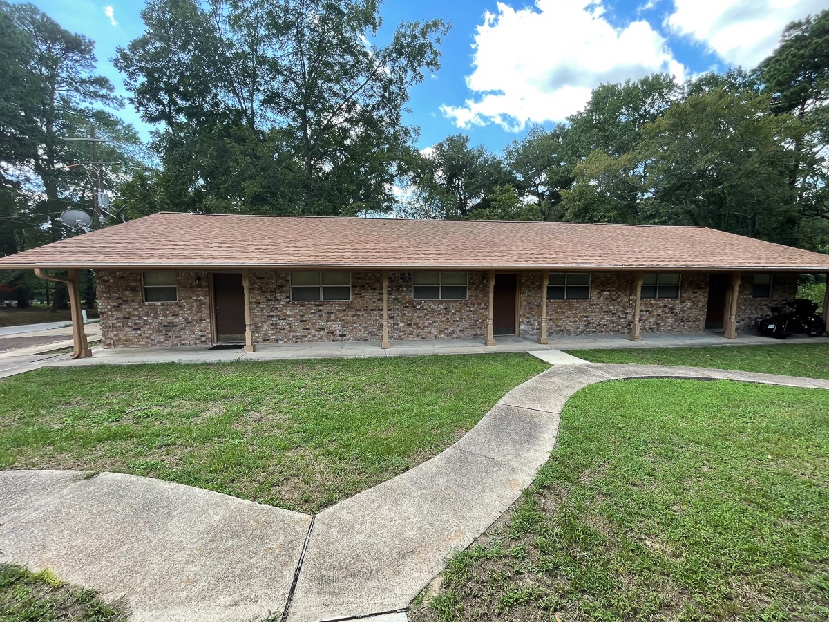 704 Cline Street Huntsville, TX 77340 - Photo 2 of 21 a front view of a house with garden