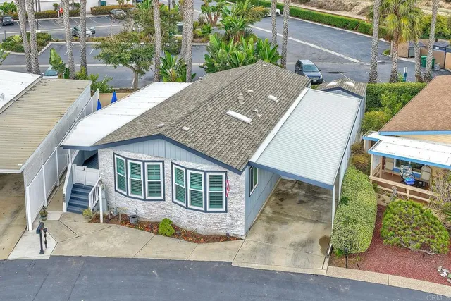 an aerial view of a house with a yard