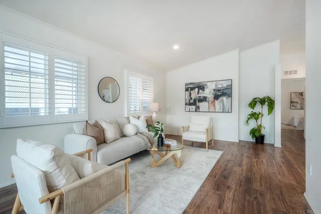 a living room with furniture and wooden floor