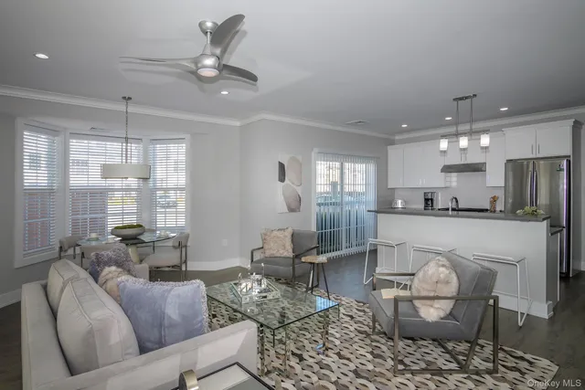 a living room with furniture and kitchen view
