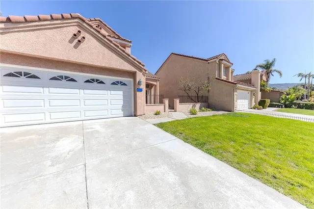 a view of a house with a yard and garage