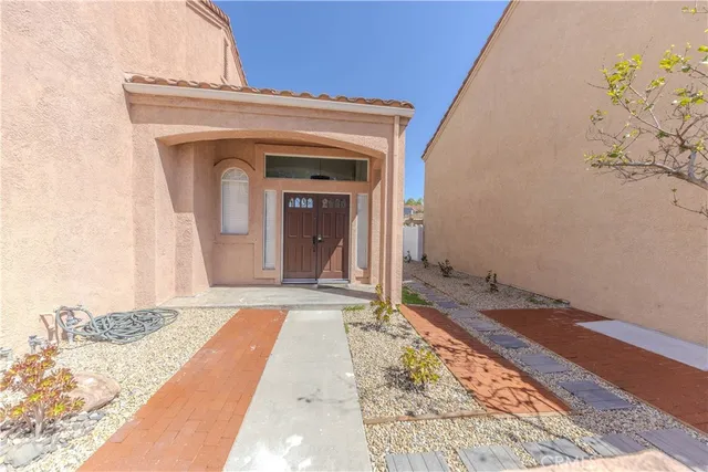 a view of a room that has a bed and a table in it