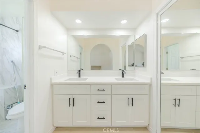 a bathroom with a double vanity sink and a mirror