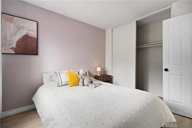 a bedroom with a bed and painting on the wall