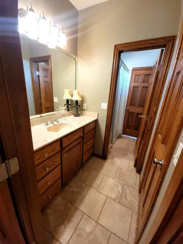 a bathroom with a double vanity sink and a mirror