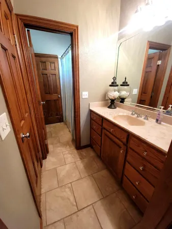 a bathroom with a double vanity sink and a mirror