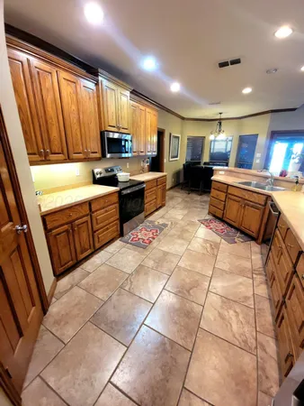 a kitchen with stainless steel appliances granite countertop a sink and cabinets