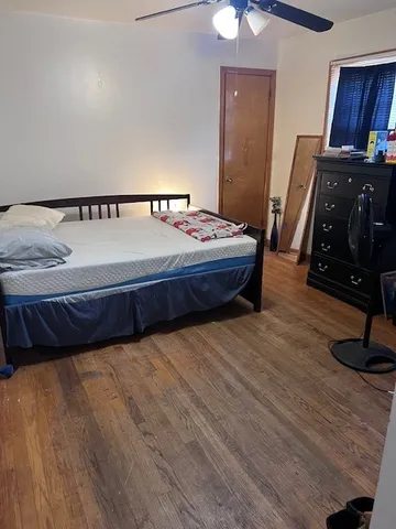 a bedroom with a bed and a mirror