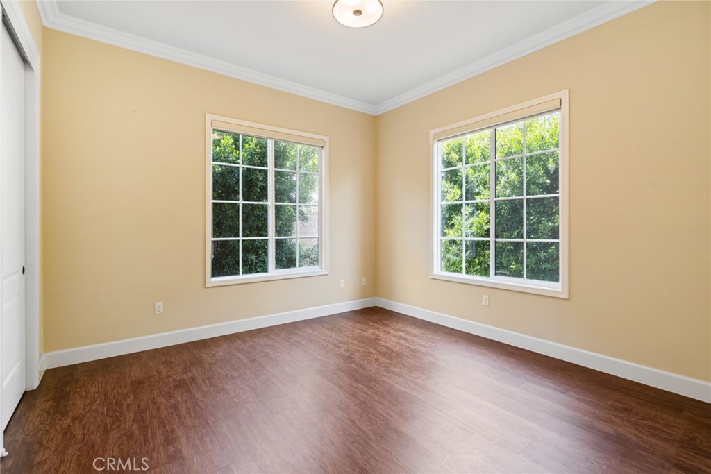 1019 Holly Avenue, Unit A Arcadia, CA 91007 - Photo 22 of 40 an empty room with wooden floor and windows