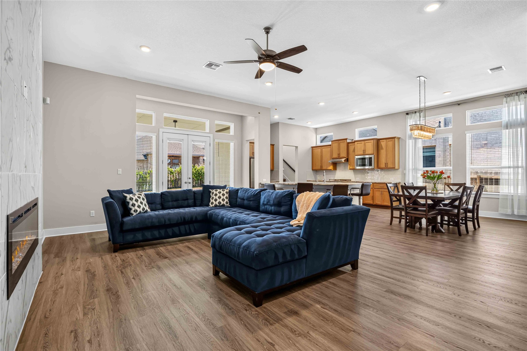 605 A Mallow Road Leander, TX 78641 - Photo 3 of 29 An open-concept living area provides ample space for relaxation and entertaining, featuring high ceilings and warm wood flooring.