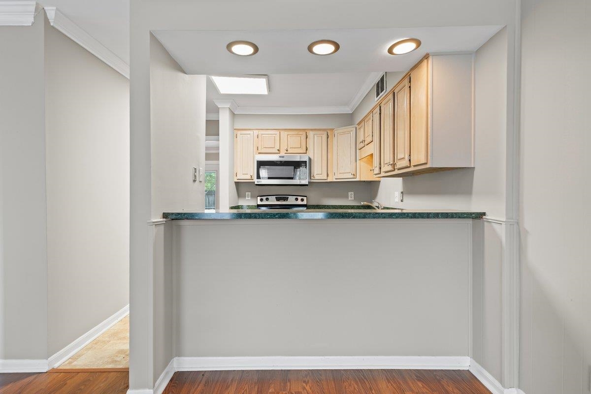 6942 Amberly Road, Unit 6942 Memphis, TN 38119 - Photo 7 of 23 a view of kitchen with granite countertop cabinets and window