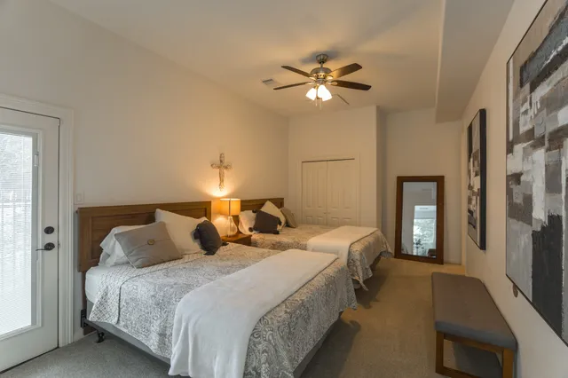 a bedroom with a bed and a chandelier