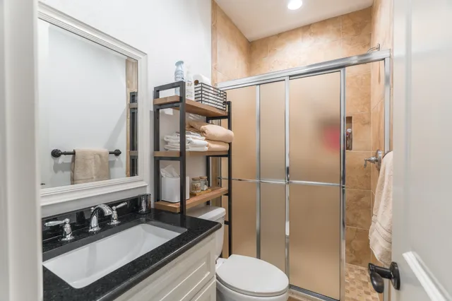 a bathroom with a toilet a sink and shower