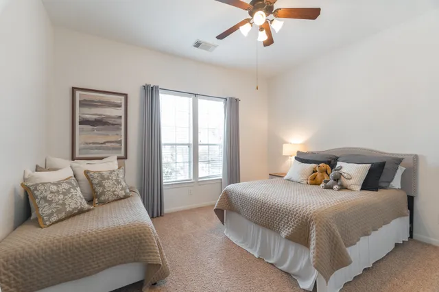 a bedroom with a large bed and a window