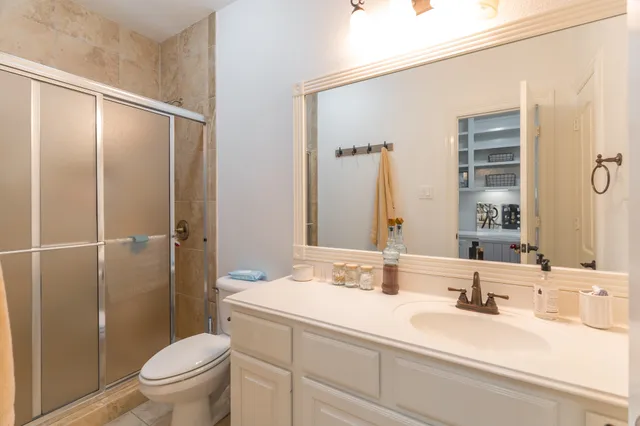 a bathroom with a sink a toilet and shower