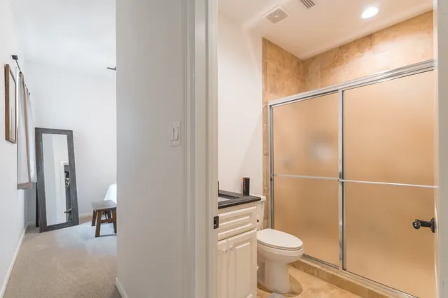 a bathroom with a toilet and a shower