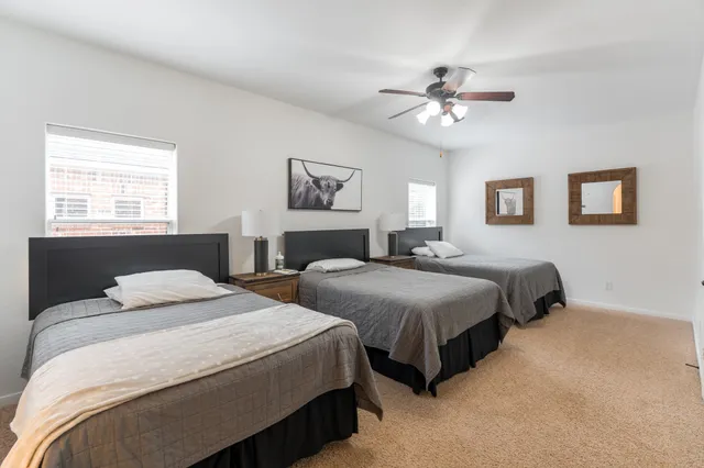a bedroom with two beds and a chandelier