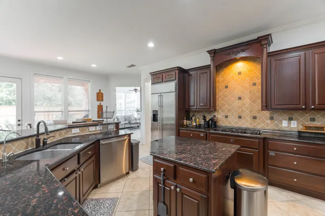 a kitchen with a sink stove and cabinets
