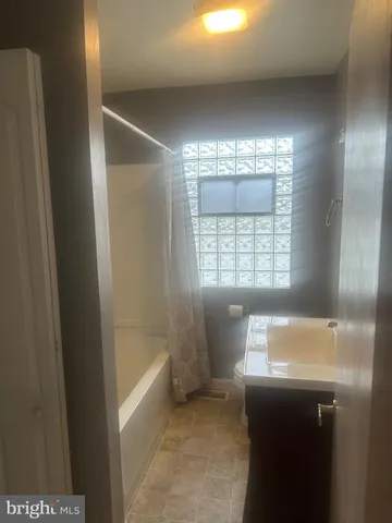 a bathroom with a bathtub and shower