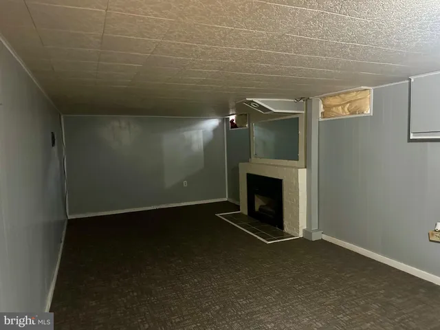 a view of an empty room with a fireplace