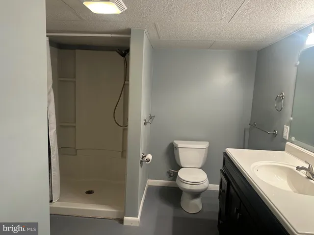 a bathroom with a toilet sink and shower