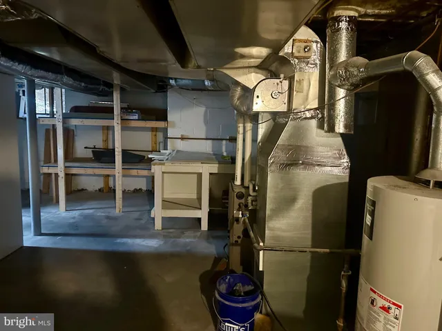 a water heater room with wooden floor