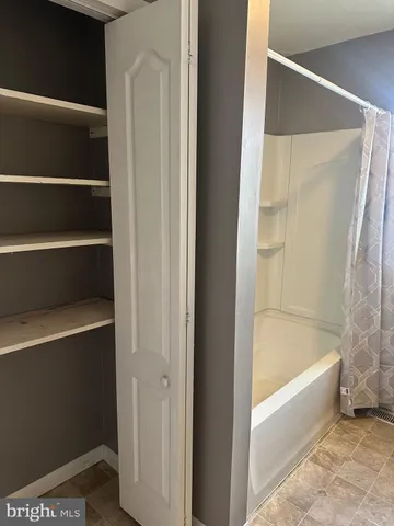 a bathroom with bathtub and a shower