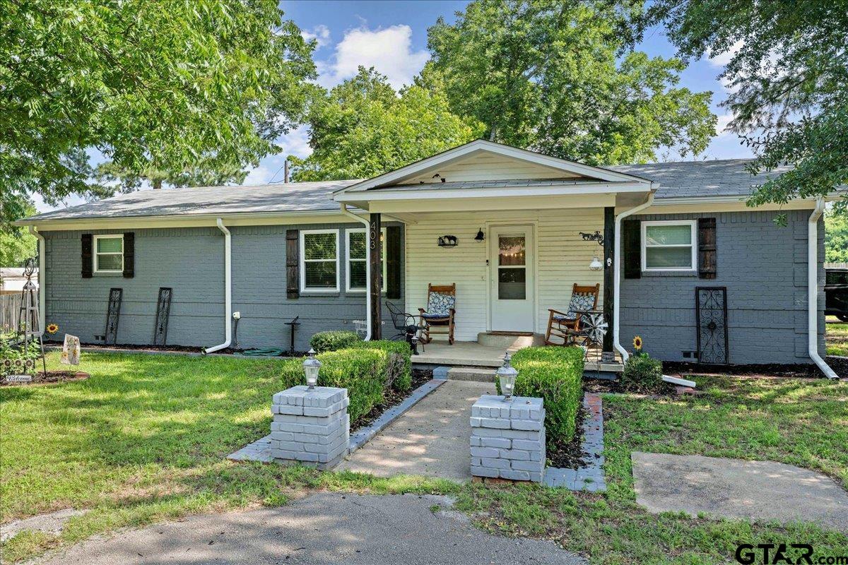 403 Kennedy Street Lindale, TX 75771 - Photo 1 of 36 a front view of a house with a yard