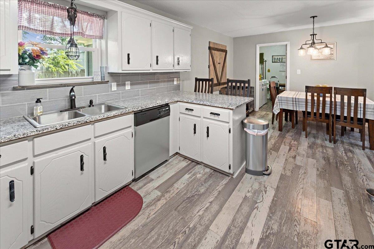 403 Kennedy Street Lindale, TX 75771 - Photo 17 of 36 a kitchen with a sink window and cabinets