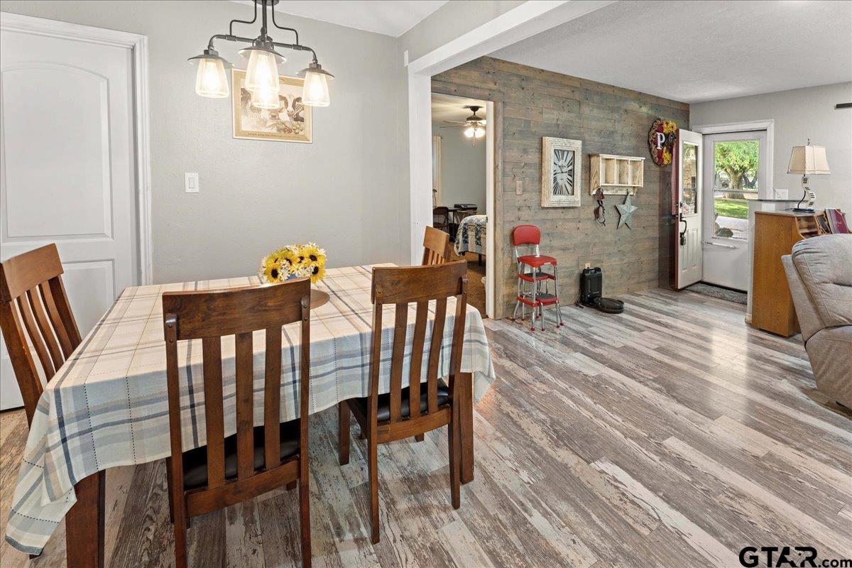 403 Kennedy Street Lindale, TX 75771 - Photo 21 of 36 a view of a dining room with furniture wooden floor and chandelier