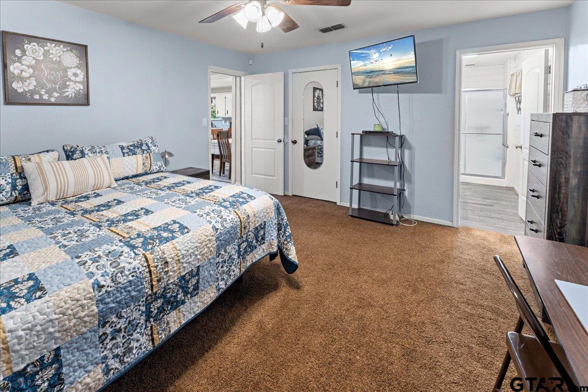 403 Kennedy Street Lindale, TX 75771 - Photo 23 of 36 a bedroom with a bed and a chandelier