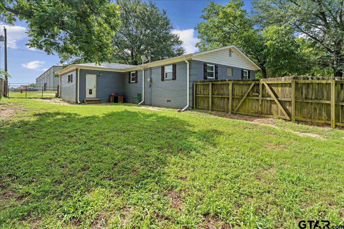 403 Kennedy Street Lindale, TX 75771 - Photo 28 of 36 a view of a house with a backyard and a tree